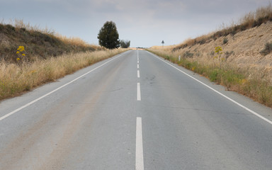 Empty country asphalt road leading to nowhere