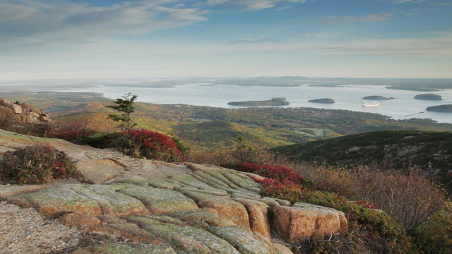 Pan of a portion of Bar Harbor and Frenchman Bay and the Porcupine Islands shortly after a muted sunrise, as seen from the top of Cadillac Mountain in Acadia National Park, Maine.