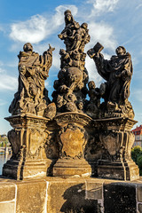 Fototapeta na wymiar Ancient sculpture of Virgin Mary surrounded by the Saints on the Charles Bridge in Prague, Czech Republic.