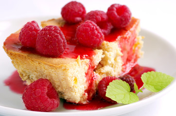 cake with raspberries and cream cheese decorated with fresh rasp