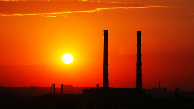 Time lapse sunset and industrial zone silhouette