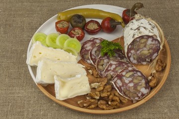 Delicious specialty food, salami with walnuts. Refreshments for important guests. Traditional specialty food. Preparation of home entertainment.
