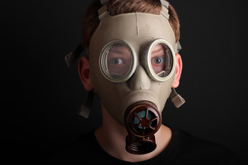 Man with gas mask on black  background