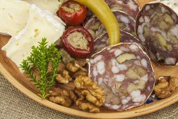 Delicious specialty food, salami with walnuts. Refreshments for important guests. Traditional specialty food. Preparation of home entertainment.
