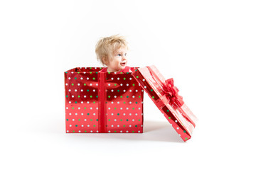 Baby inside red Christmas gift box