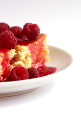 cake with raspberries and cream cheese decorated with fresh rasp
