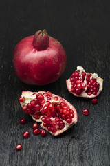 pomegranate on black wood