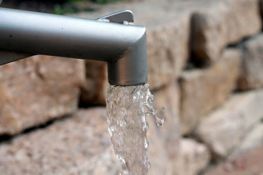 Water running from an outdoor faucet