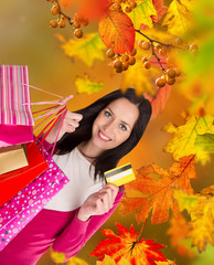 Beautiful woman holding shopping bags, buying in autumn season.