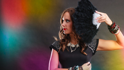 beautiful brunette woman with black fan in hand