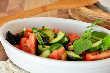 Fresh mixed vegetable salad with cucumber and tomatoes with balsamic