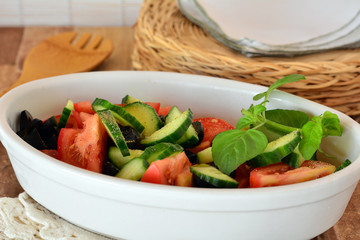 Fresh mixed vegetable salad with cucumber and tomatoes with balsamic