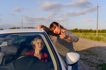 Woman giving directions to a female driver