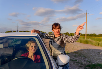 Woman giving directions to a female driver