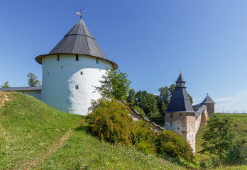 Towers and walls of the old fortress summer day. Pskov-Caves Holy Dormition Monastery in Russia