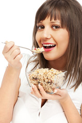 Young woman eating cereal breakfast