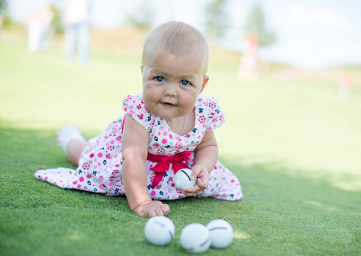 little girl playing golf