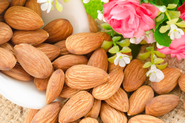 Almonds in white cup with pink flower.