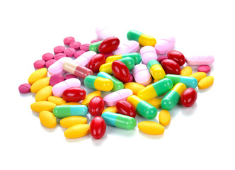 Colored pills and tablets on a white background