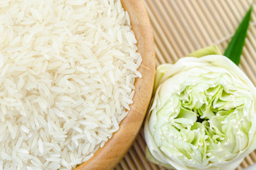 Raw rice jasmine on wooden bowl.