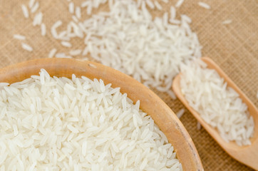 Raw rice in wooden bowl.