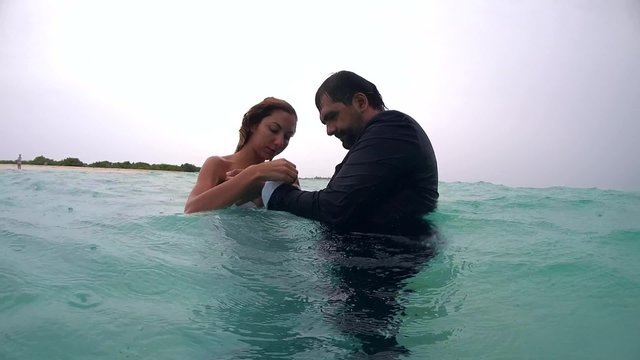 UNDERWATER: The bride and groom are preparing for an underwater photo shoot, Indian Ocean, Maldives
