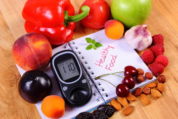 Fruits and vegetables with glucometer and notebook for notes, healthy food, diabetes