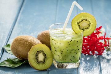 kiwi juice with fresh fruits on blue wooden table