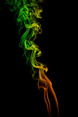 Abstract yellow - green - orange smoke from aromatic sticks.