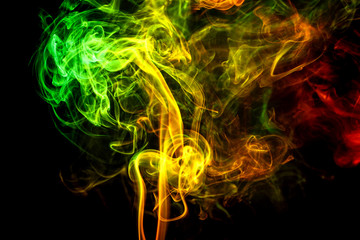 Abstract yellow - green - orange smoke from aromatic sticks.