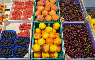 Peaches, cherries blackberries for sale at a market