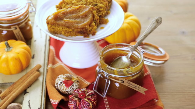 Homemade pumpkin butter with pumpking bread on the table