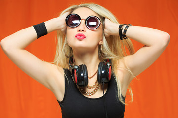 young pretty hipster woman listening music and dancing. 