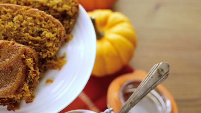 Homemade pumpkin butter with pumpking bread on the table