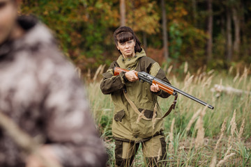 Fototapeta premium hunters in camouflage clothes ready to hunt with hunting gun