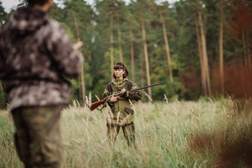 hunters in camouflage clothes ready to hunt with hunting gun
