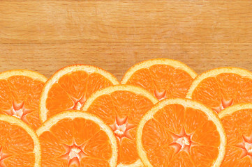 fresh orange slices on wooden cutting board