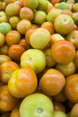 Close up a pile of fresh tomato in the market 
