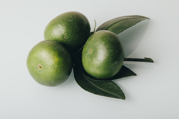  Asian green mandarin on a white background. Vitamins, green mandarin, juicy, aromatic fruit, healthy and tastes great.