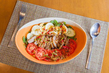 Spicy pork salad with vegetables and eggs , Asian style food