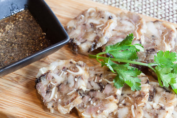 stuffed pork leg served with sauce , Asian style food