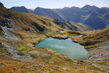 Fototapeta na wymiar Glacial lake between mountains