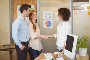 Business woman shaking hand with client