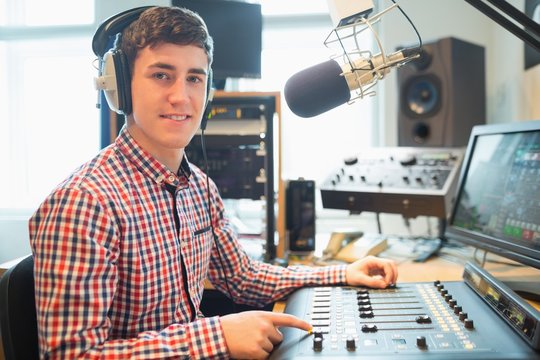 Portrait of radio host using sound mixer