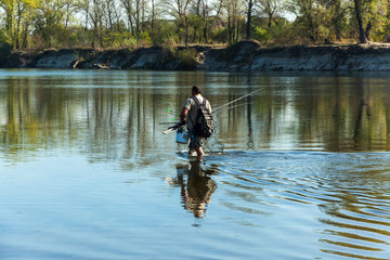 fisherman on the river, fisherman changes the place of fishing,