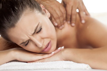 Fototapeta na wymiar beautiful young woman suffering the unpleasant massage