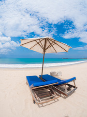 beds and umbrella on a beach