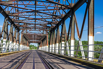 Old railway bridge, made of wood and steel.
