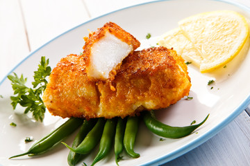 Fish dish - fried fish fillets and vegetables 