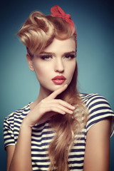 Portrait of a beautiful blonde with red scarf on the head